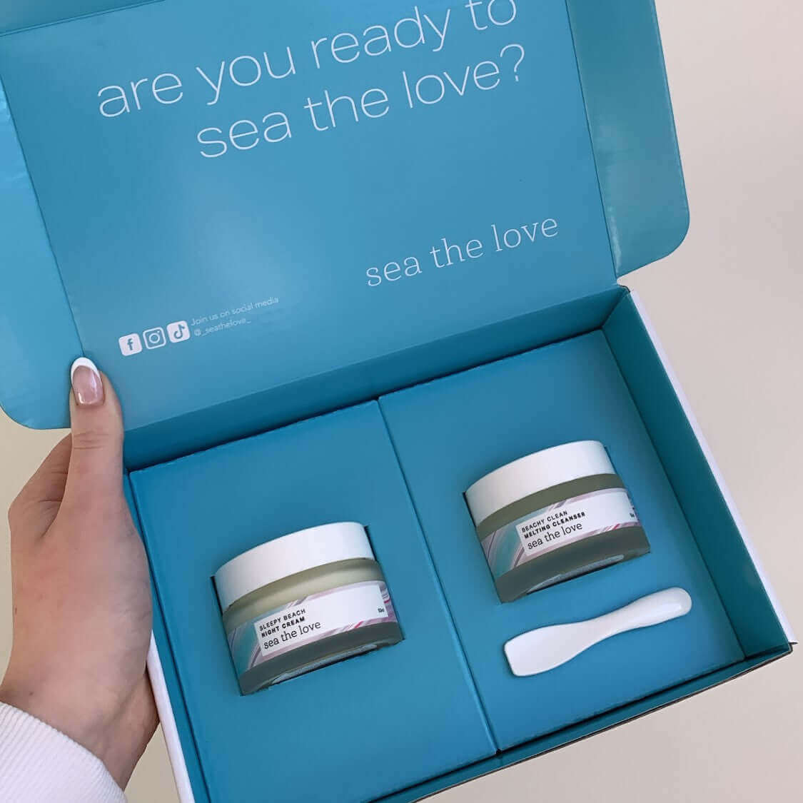 A jar of the Beachy Clean Melting Cleanser and the Sleepy Beach Night Cream in a blue box from Sea the Love - ocean inspired skincare.